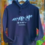 Black hoodie with white graphic design on a hanger against a colorful background