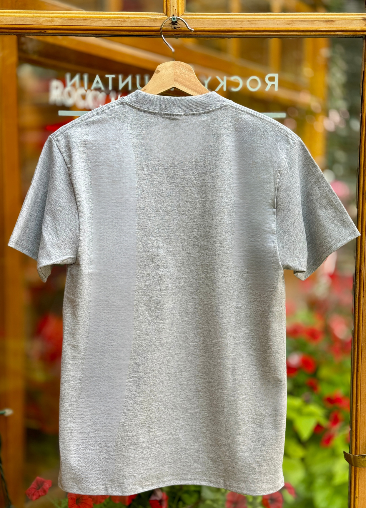 Grey t-shirt on a hanger with a blurred background