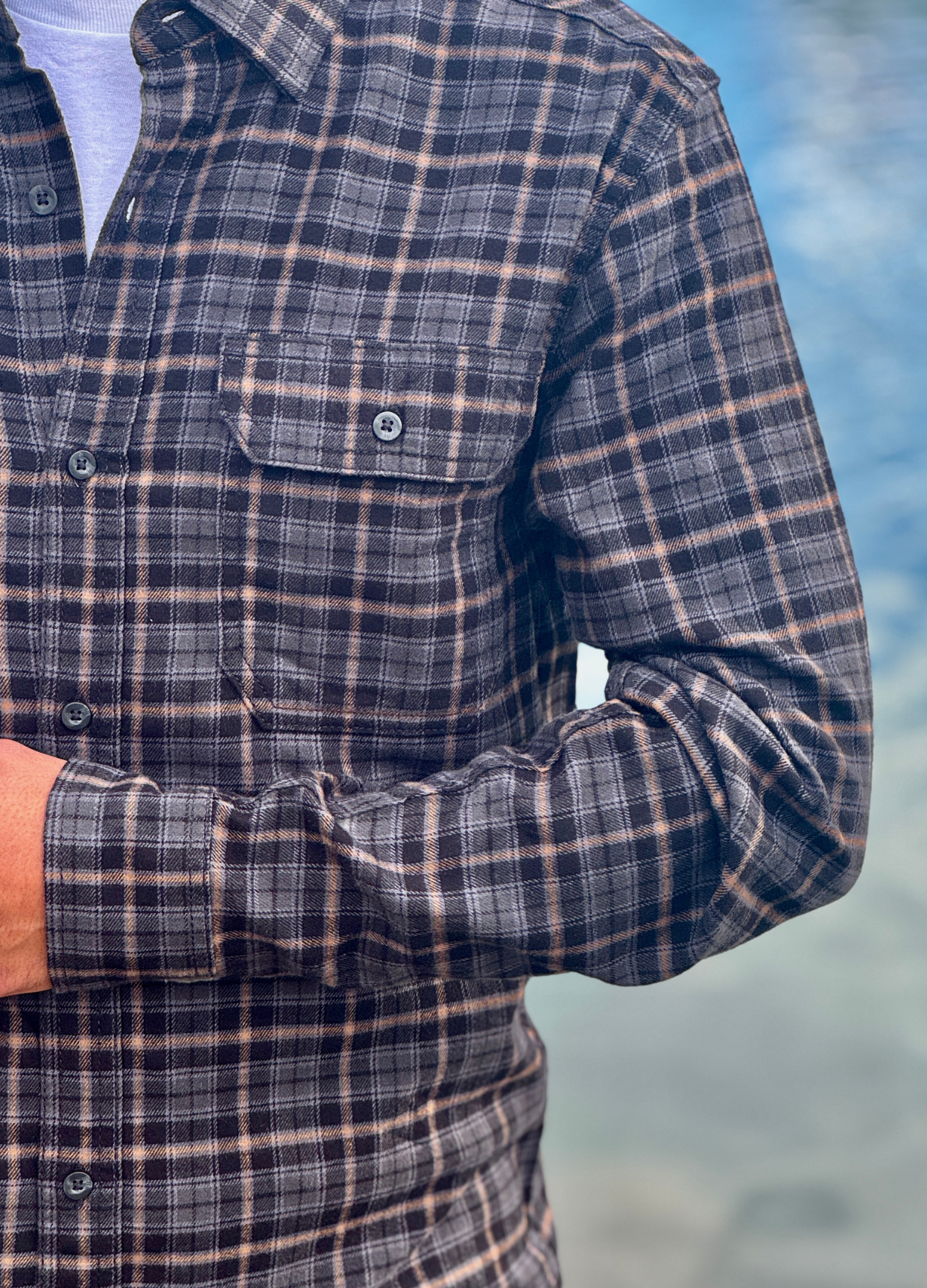 Plaid shirt worn by a person with a blurred background