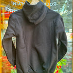 Kids Black hoodie on a hanger with a blurred store interior background