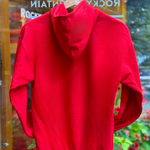 Red hoodie on a hanger with a blurred background