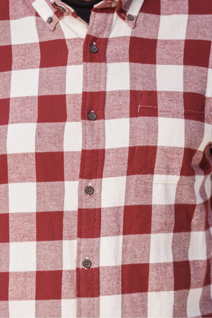 Close up of a burgundy and white buffalo check flannel shirt.