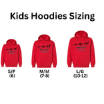 Red kids hoodies with size chart labels on a white background. Banff, Canada