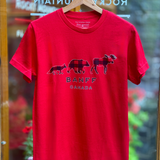 Red t-shirt with 'Banff Canada' design on a hanger in front of a store window.