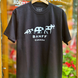 Black t-shirt with white text and graphics on a hanger against a blurred background
