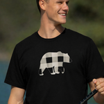 Man wearing a black t-shirt with a bear graphic, holding a fishing rod outdoors.
