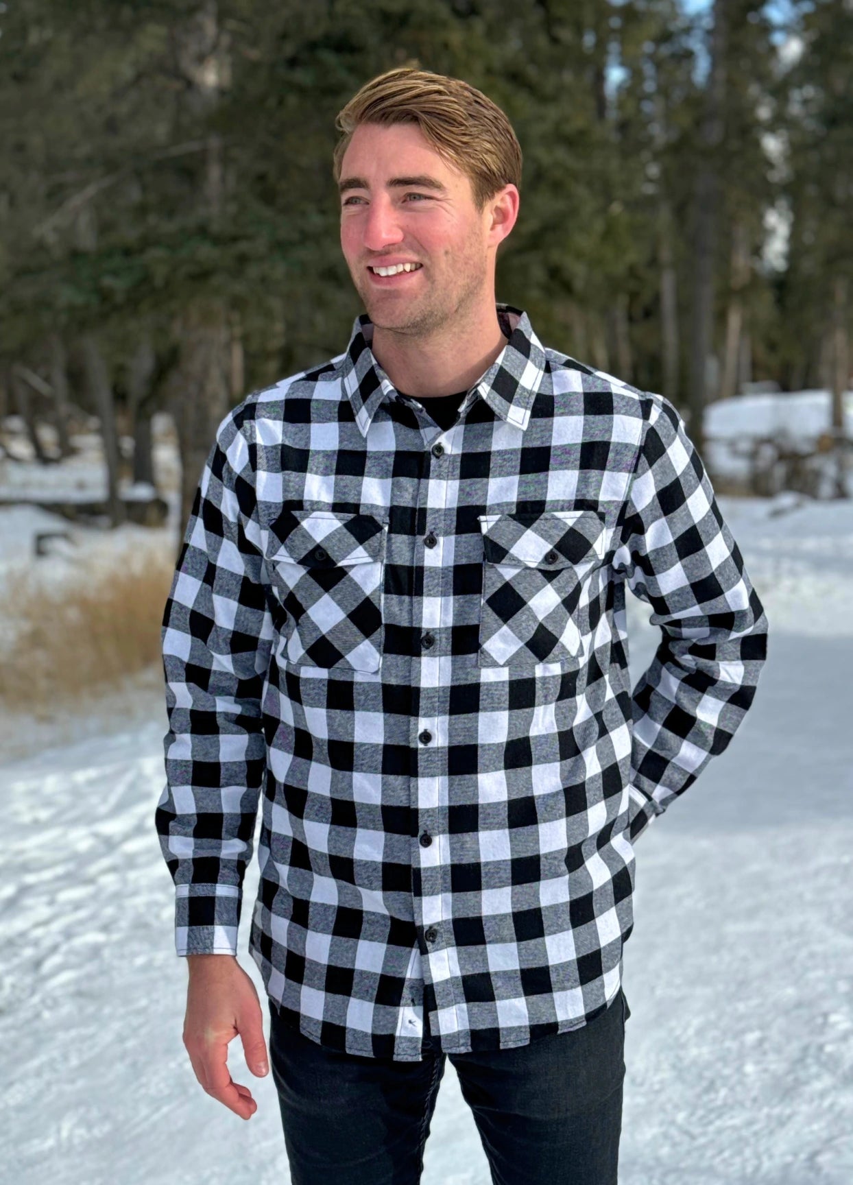 Classic Black and White Buffalo Check Shirt taken outside in the snow in Banff, Canada. The shirt has 2 front pockets and is fitted.