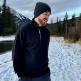 Black quarter zip polo with silver zip with canada flag logo on left arm.