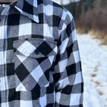 The outer layer is flannel, and the inside is a lightweight fibre quilted layer. Wear it on its own or as a layering piece!