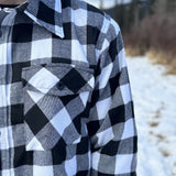 The outer layer is flannel, and the inside is a lightweight fibre quilted layer. Wear it on its own or as a layering piece!