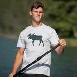 Man wearing a t-shirt with a moose graphic outdoors