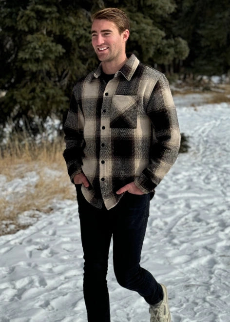 Man walking in snow in Canada wearing our brown Wool Blend Flannel Shacket with Herringbone Weave