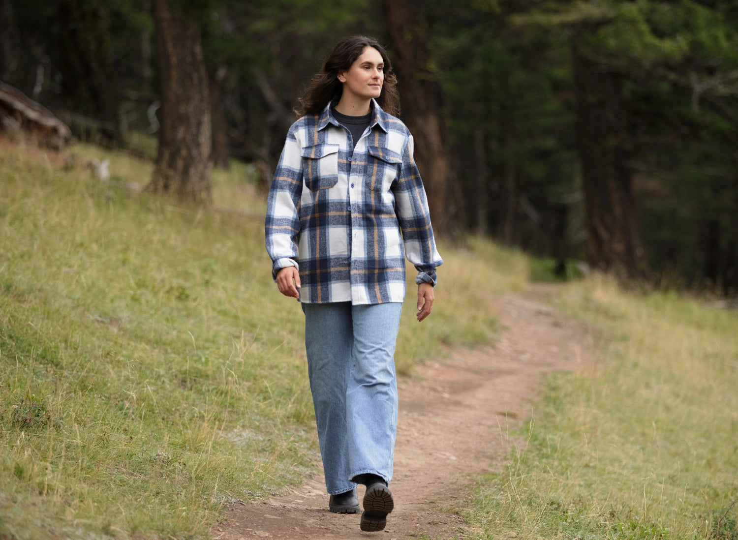 Girl wearing the gender neutral Brush Flannel Shacket in Blue & Caramel Plaid.