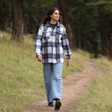Girl wearing the gender neutral Brush Flannel Shacket in Blue & Caramel Plaid.