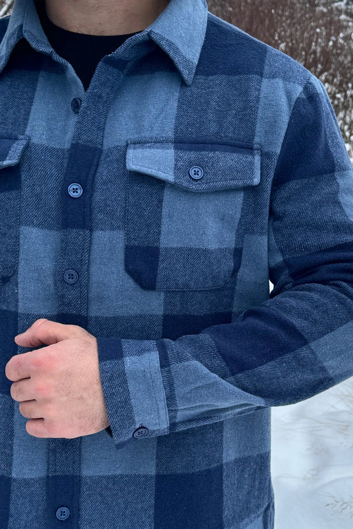 Close up of buttons on the cuff and front left pocket of the Brush Flannel Shacket / Navy & Blue Large Buffalo Check