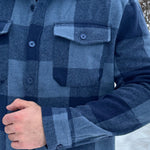 Close up of buttons on the cuff and front left pocket of the Brush Flannel Shacket / Navy & Blue Large Buffalo Check