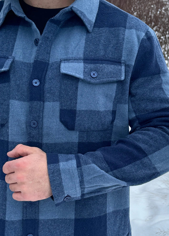 Close up of buttons on the cuff and front left pocket of the Brush Flannel Shacket / Navy & Blue Large Buffalo Check
