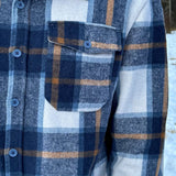 Close up of pocket in Blue & Caramel Plaid Jacket. 75% polyester, 25% cotton. 2 breast pocket.