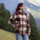 A women stood in a field with mountains in the background