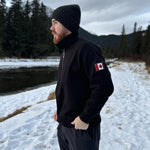 Black quarter zip polo with canada flag logo on left arm.