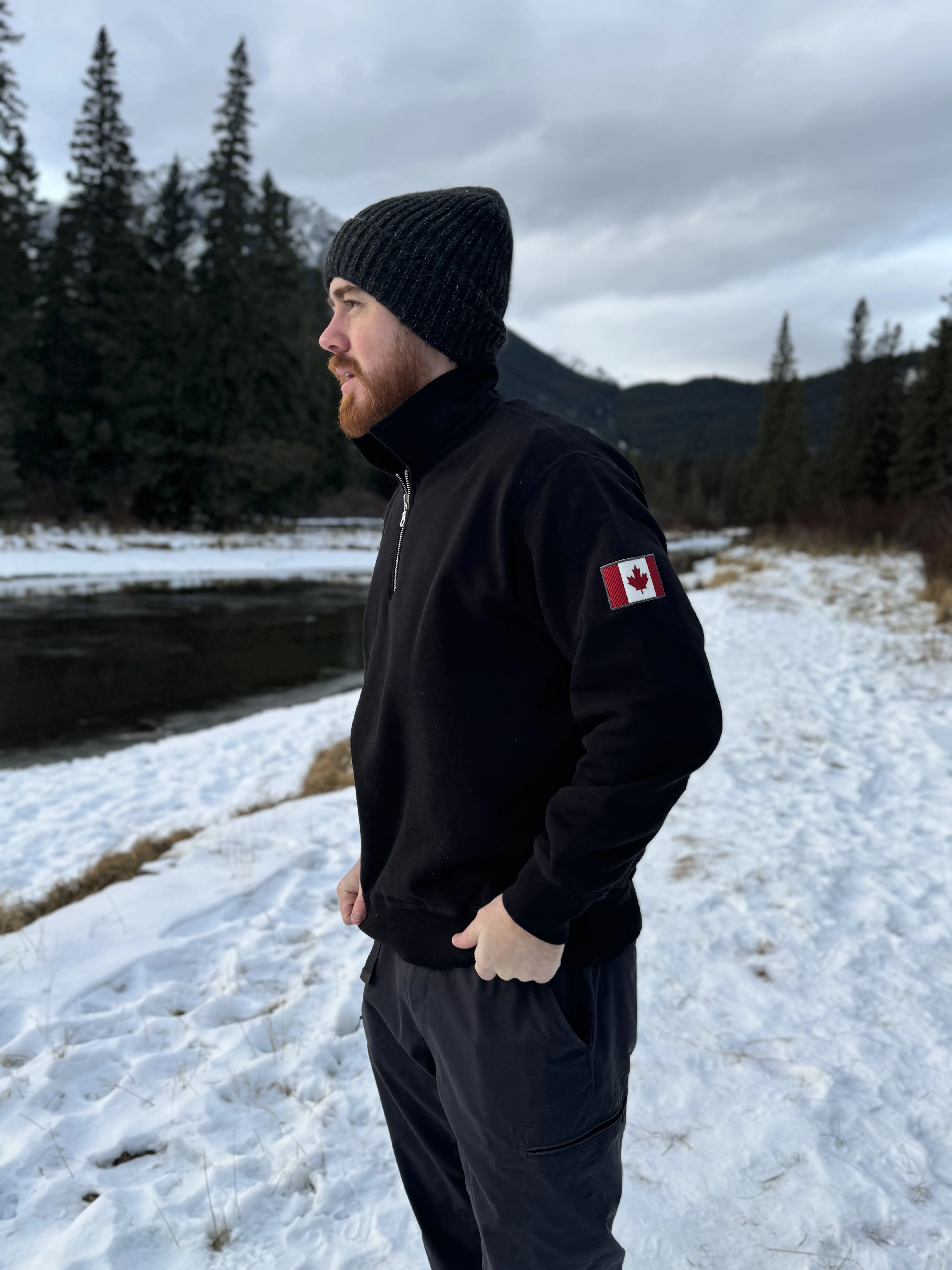 Black quarter zip polo with canada flag logo on left arm.
