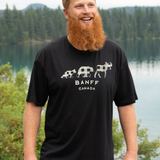 Man wearing a black 'Banff Canada' t-shirt with a scenic background