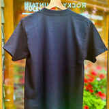 Black t-shirt on a hanger with a blurred background