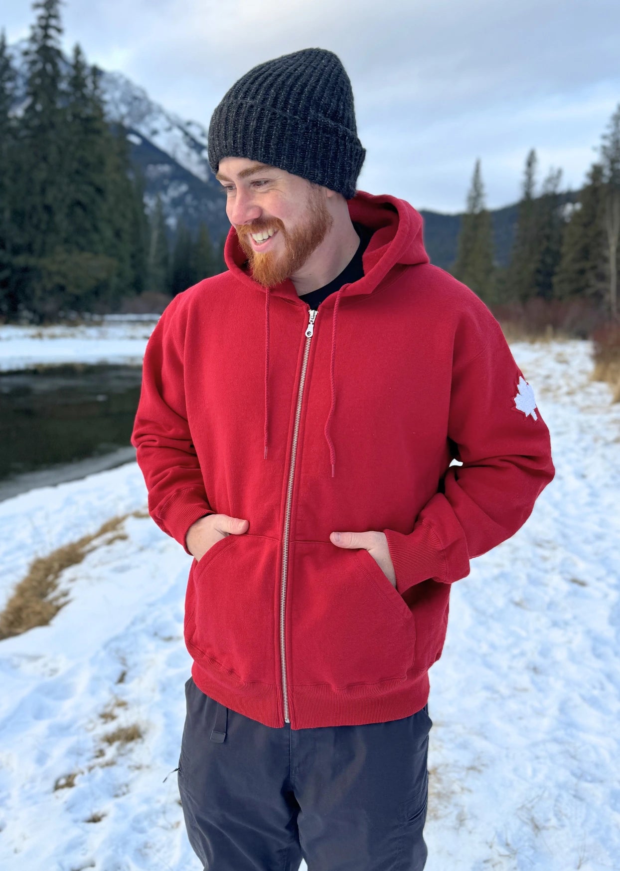 Full Zip red Hoodie with white canada maple leaf logo on left arm.