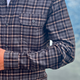 Plaid shirt worn by a person with a blurred background
