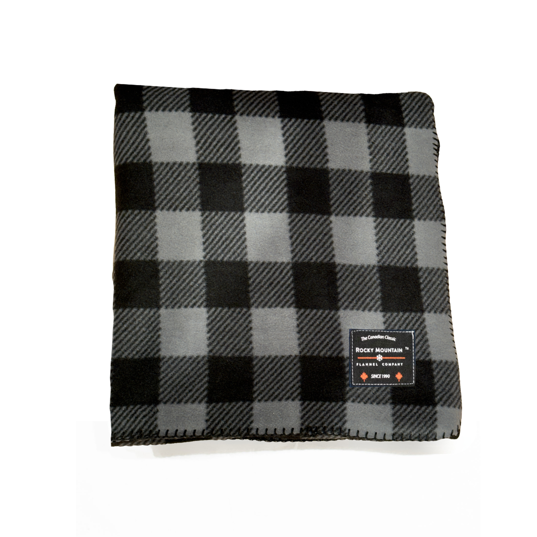 Black and gray checkered blanket with a brand label on a white background
