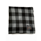 Black and gray checkered blanket with a brand label on a white background