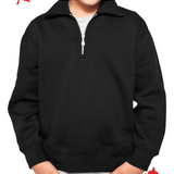 A kid wearing a black unisex polo shirt with a quarter zip at the neckline.