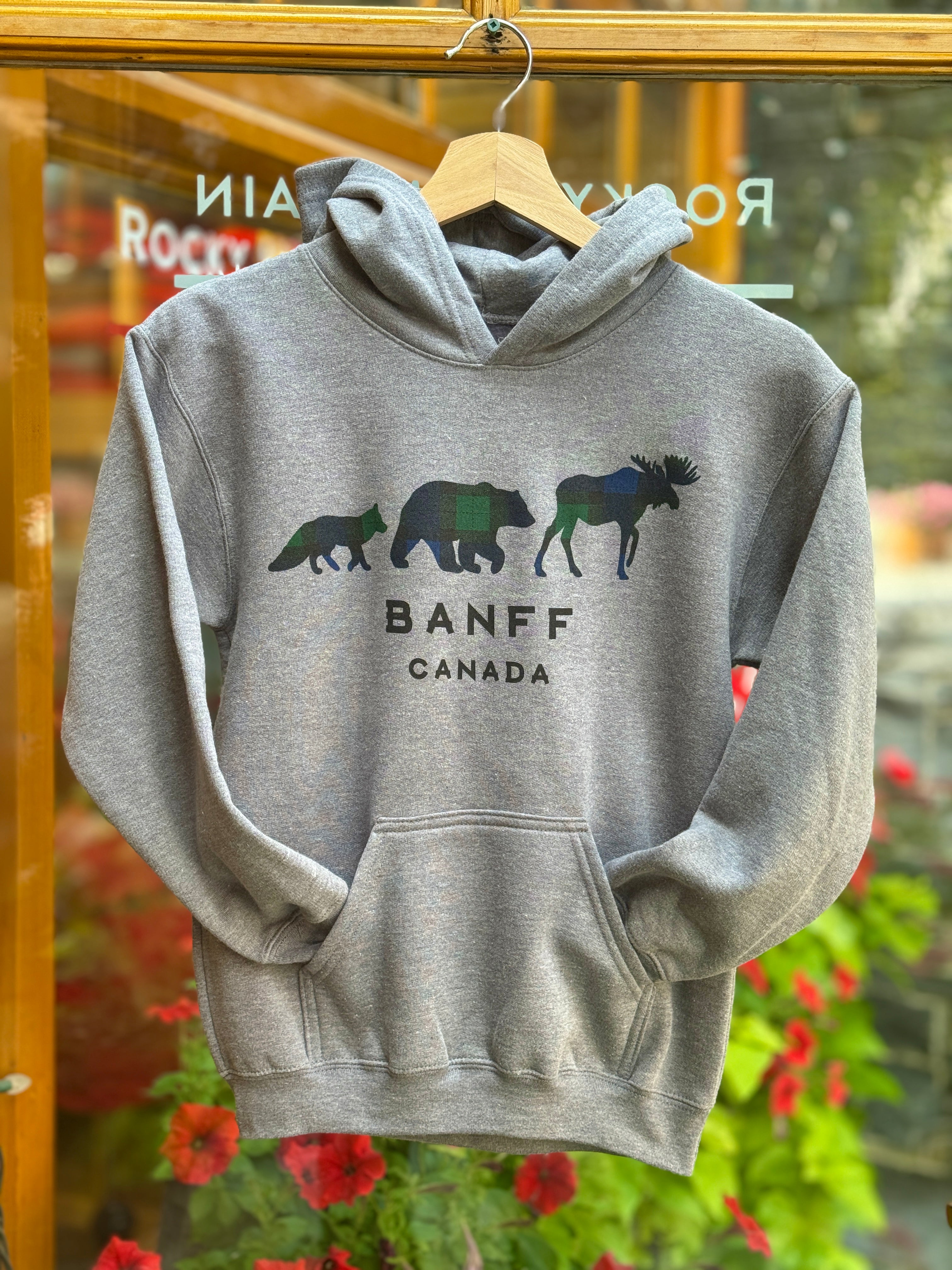 Kids grey hoodie with bear and moose design and 'Banff Canada' text on a hanger.