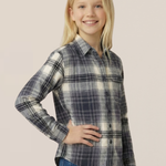 Young girl wearing a plaid shirt and jeans on a beige background