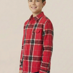 Child wearing a red plaid shirt on a beige background