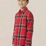 Child wearing a red plaid shirt on a beige background