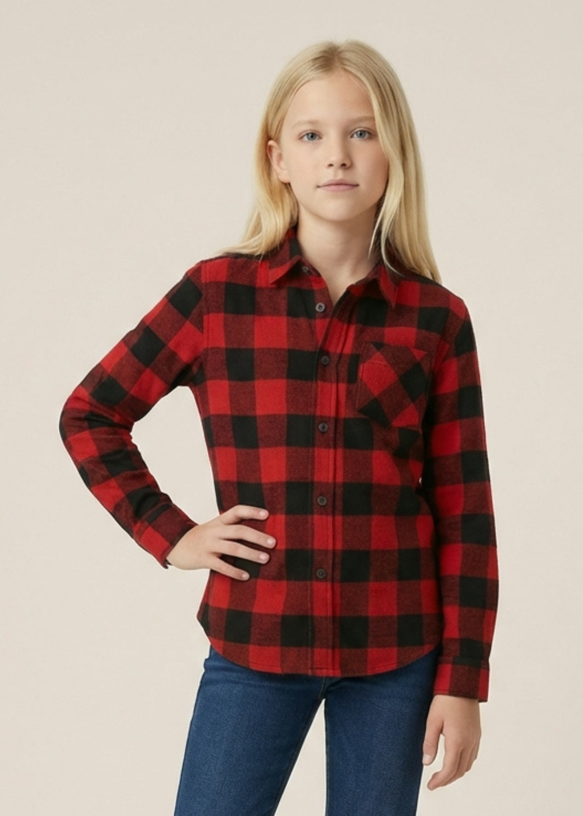 Youth girl wearing a unisex red and black buffalo check shirt with a plain background