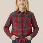 Young girl wearing a royal stewart tartan shirt and blue jeans on a beige background