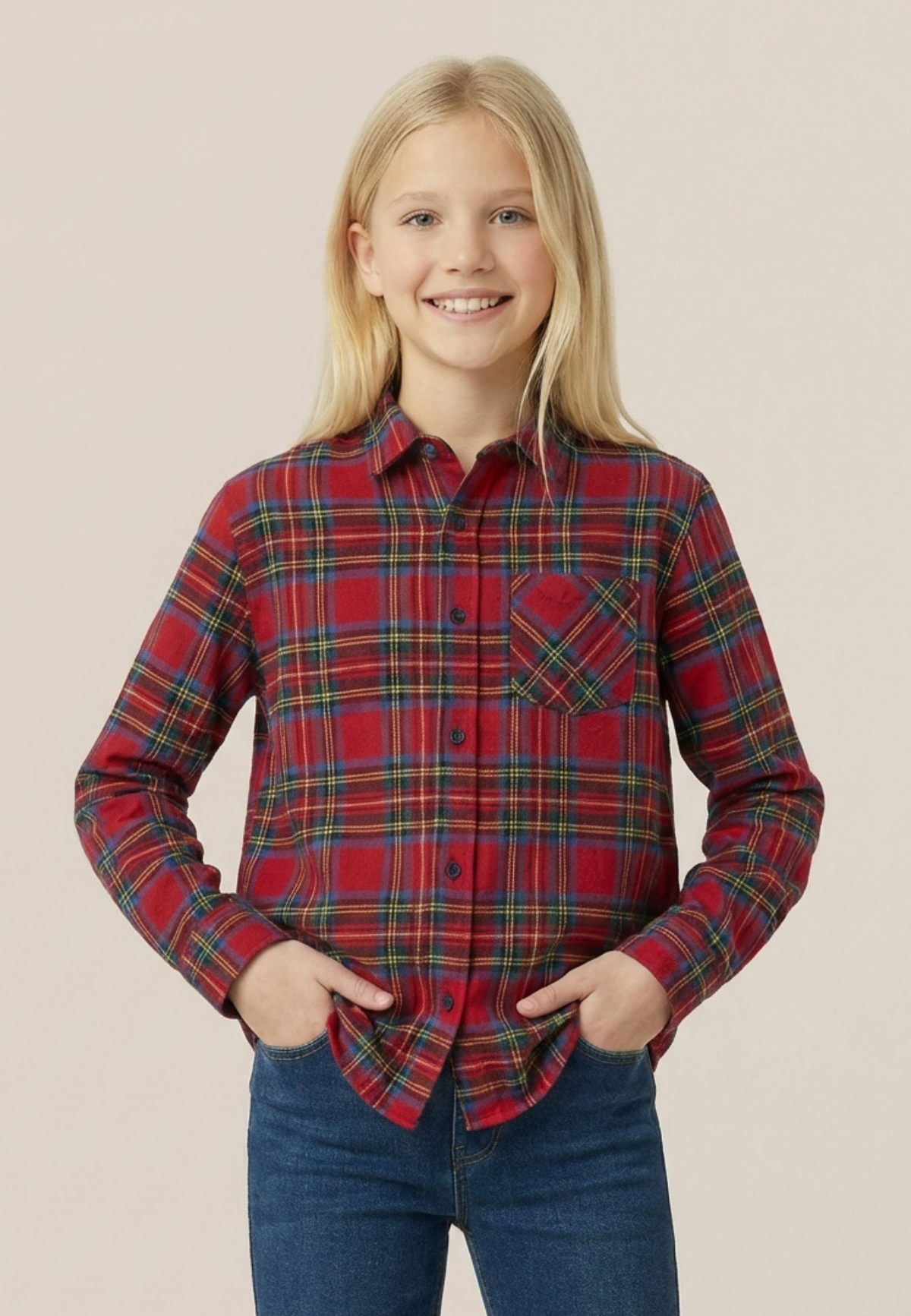 Young girl wearing a royal stewart tartan shirt and blue jeans on a beige background