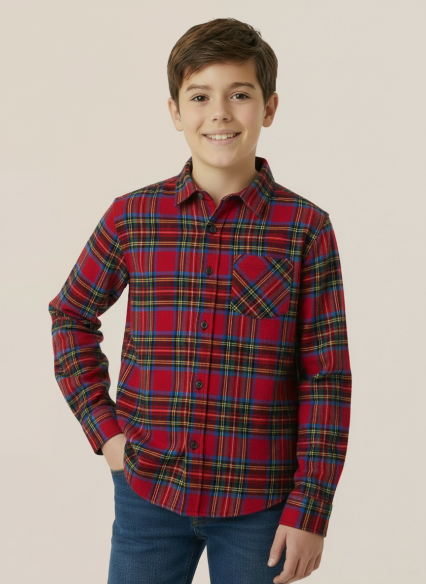 Child wearing a royal stewart tartan shirt against a beige background