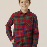 Child wearing a royal stewart tartan shirt against a beige background