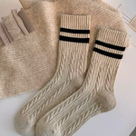 Beige wool socks with black stripes on a light background