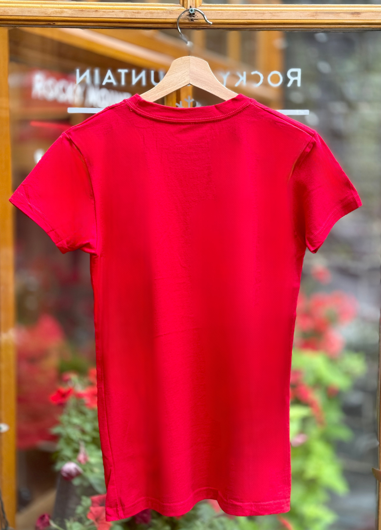 Red t-shirt on a hanger with a blurred background