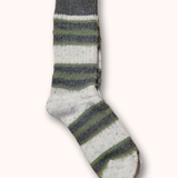 Striped sock with gray, green, and white colors on a white background