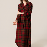 Woman wearing a red plaid nightgown on a beige background