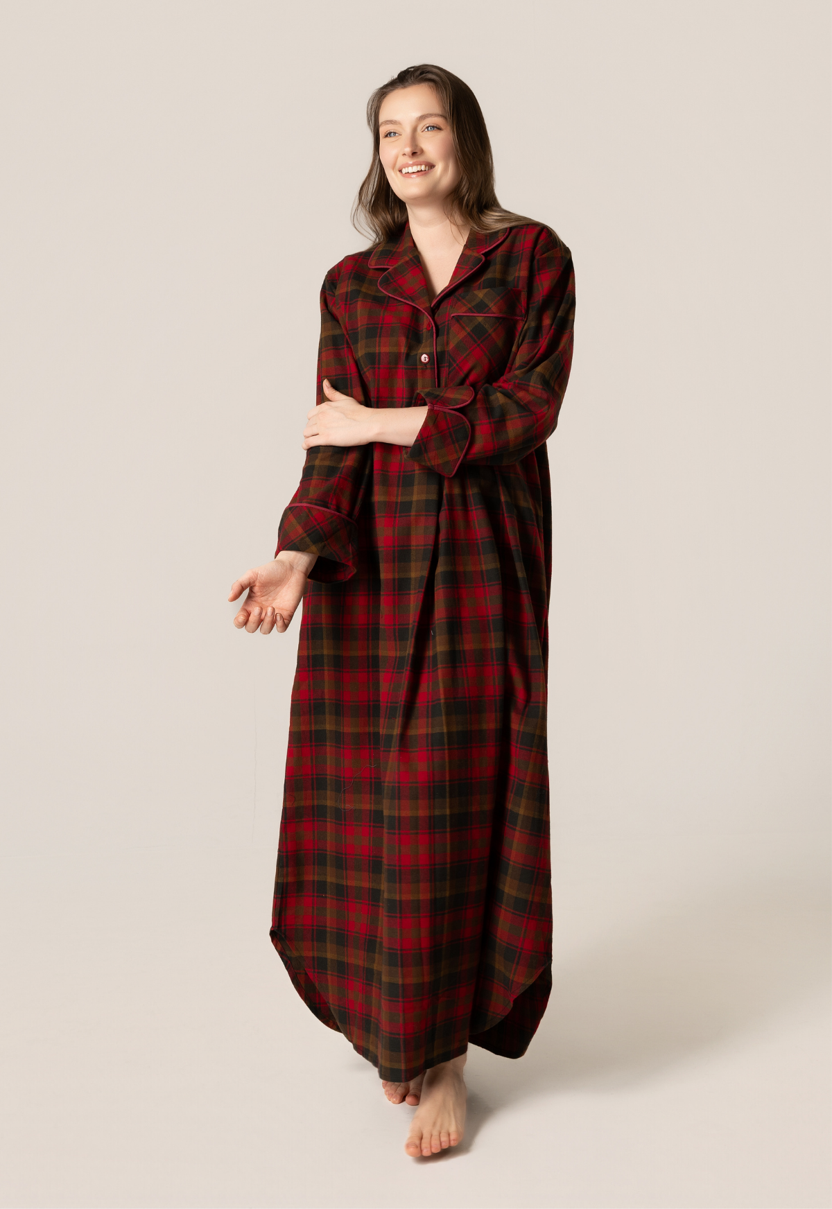 Woman wearing a red plaid nightgown on a beige background