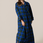 Woman wearing a blue plaid robe on a plain background