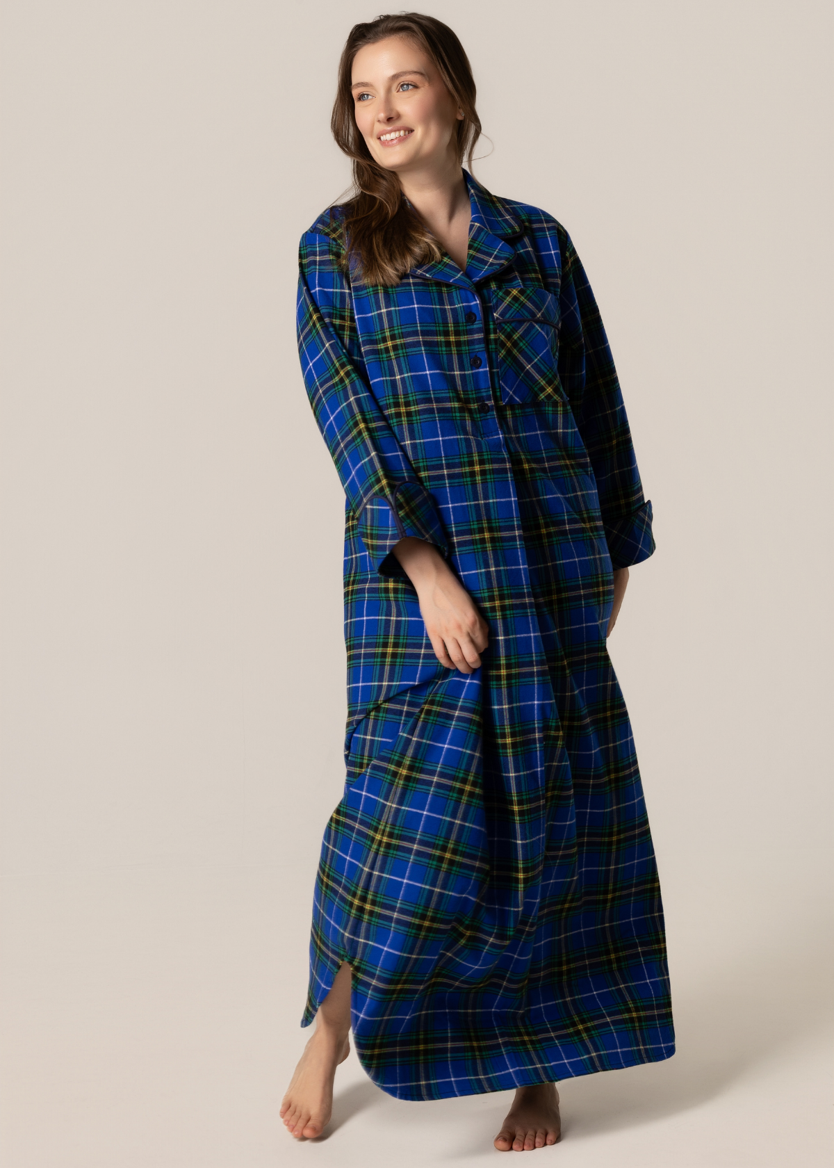 Woman wearing a blue plaid robe on a plain background