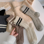Collection of woolsocks in various colors on a white surface.