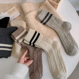 Collection of woolsocks in various colors on a white surface.